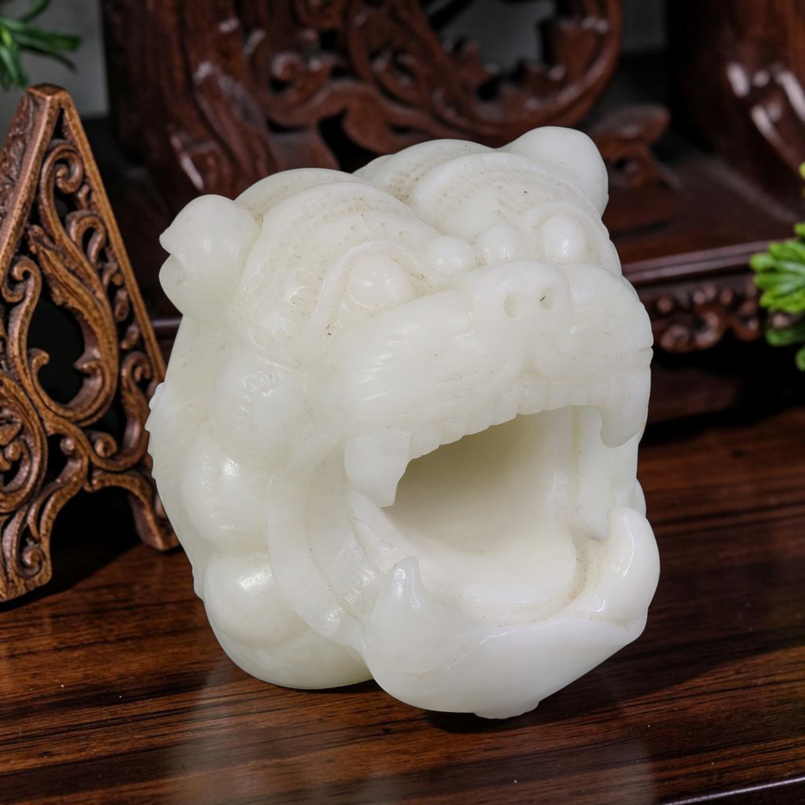 White Nephrite Jade Lion Head - Chinese Carved Figurine, 62AS: Crafted from solid white nephrite jade, this carving displays refined hand chiseling defining the lion's rounded cranial structure, raised circular eyes, flared nostrils, and wide open maw with promin