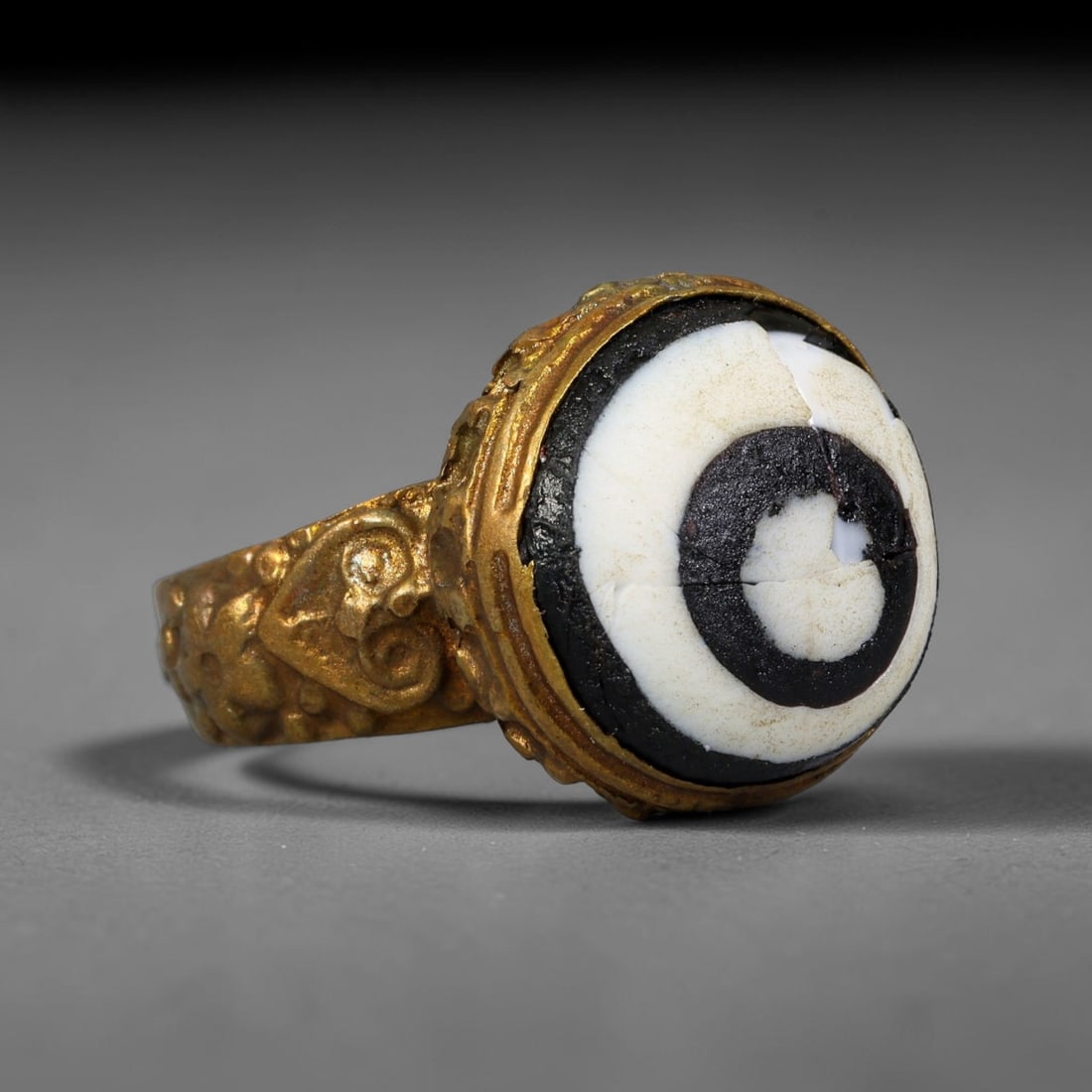 Antique Qajar Dynasty Copper Alloy Ring Set With Banded Glass Bead Cabochon, 58AC: Historic wearable signet ring crafted from textured copper alloy metal, sized to US ring size 8.25, originating from Qajar Persian artistic and adornment traditions of late medieval Iran. Copper alloy