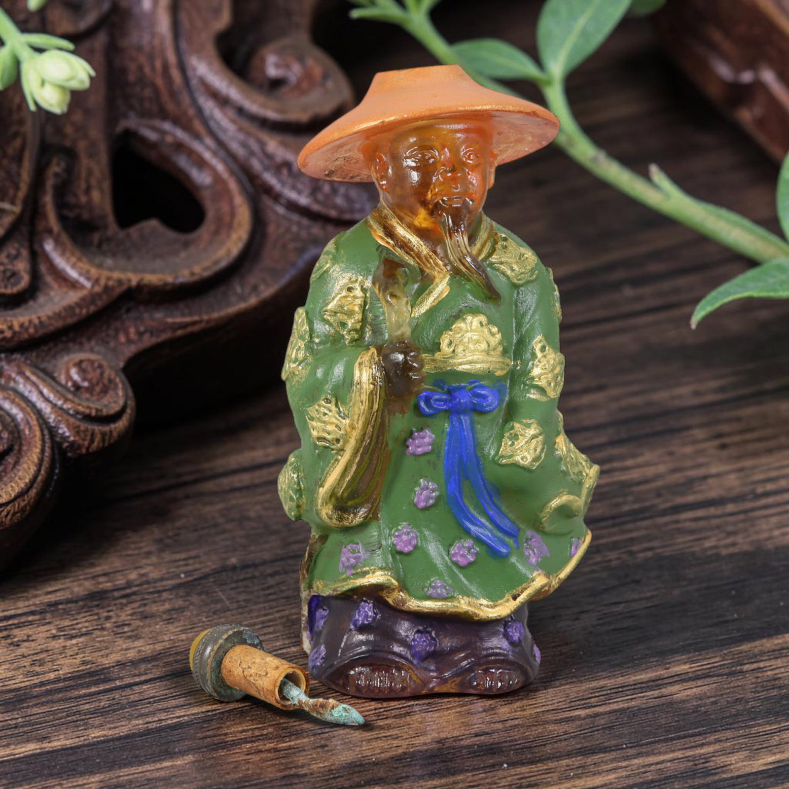 Vintage Chinese Liuli Glass Snuff Bottle - Scholar with Straw Hat, 56AS: This snuff bottle is moulded from translucent amber liuli glass, shaped as a robed scholar wearing a straw hat. The green robe features raised gilded cloud patterns accented with hand-painted purple f