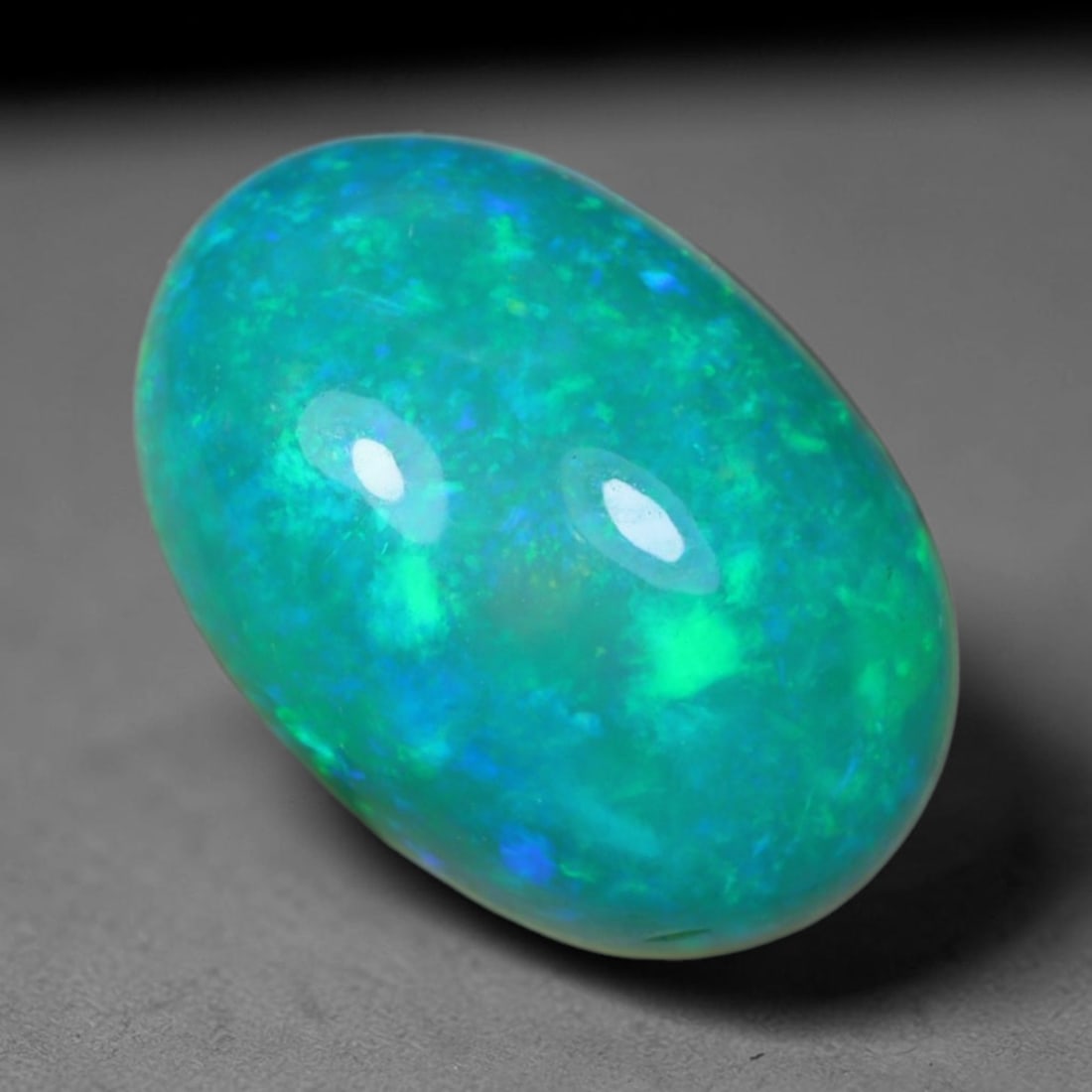 3.04 Carats Natural Ethiopian Welo Teal Blue Green Opal Cabochon Loose Gemstone, 45AG: This lustrous polished opal features a rich teal base filled with swirling patches of neon mint green and bright cerulean blue shifting play of color, measured at 11.3x8x6mm, its cool aquatic multi-hu