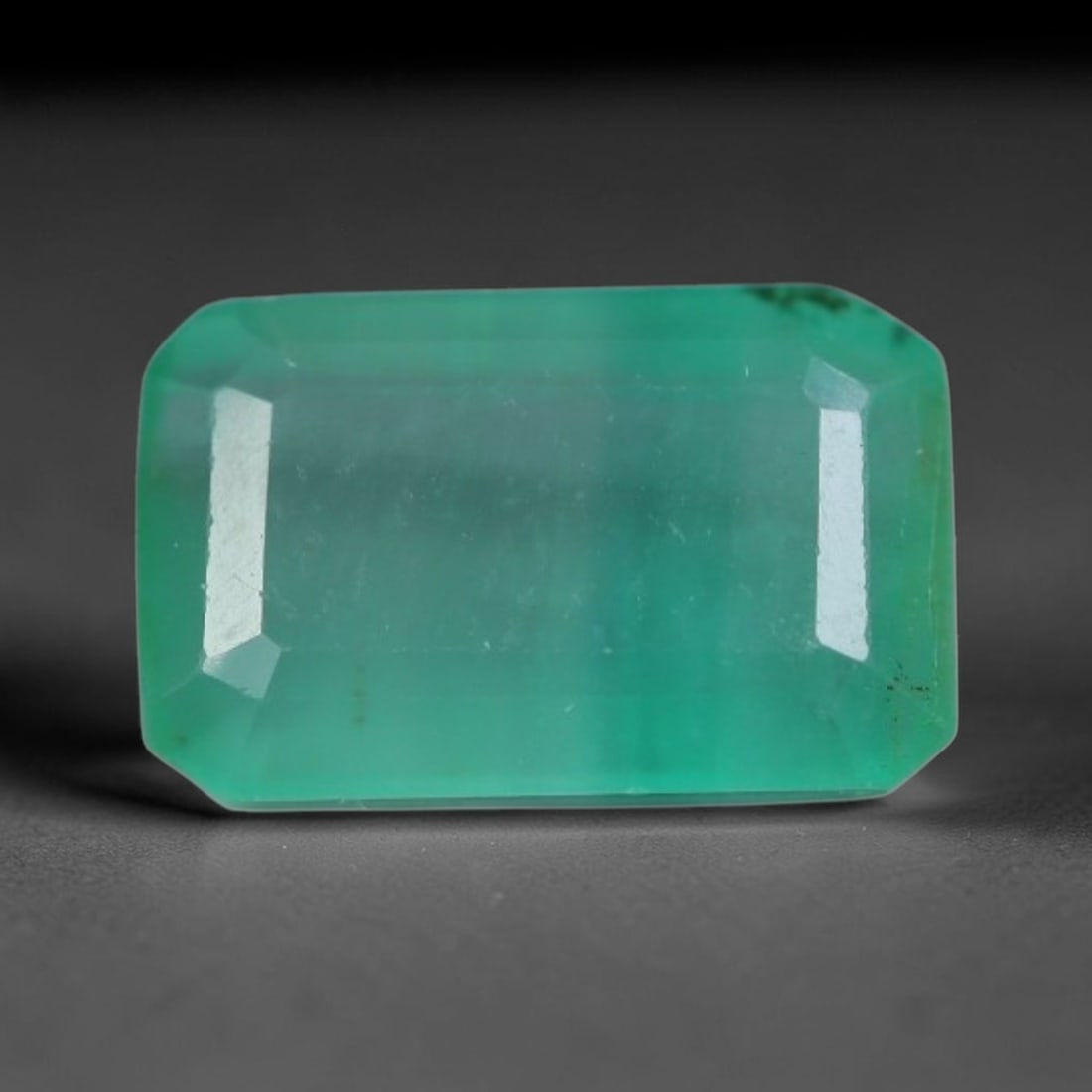 1.07 Carats Natural Zambian Green Emerald Loose Gemstone, 94AG: This green Zambian emerald holds smooth even saturation with subtle faint natural internal markings lending authentic organic character, measured at 7.6x4.8x3mm, its calm cool green tone delivers unde