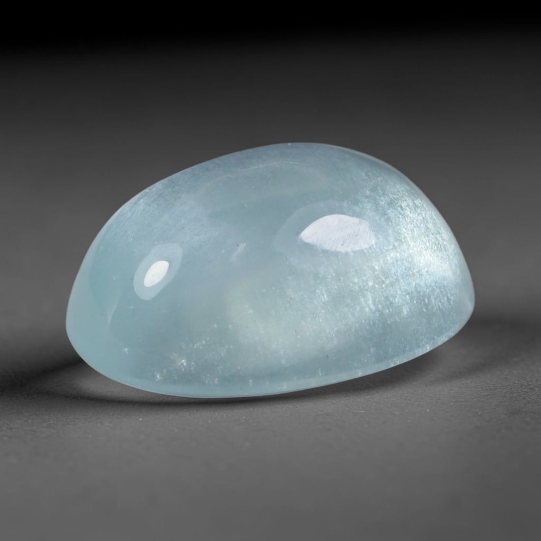 3.51 Carats Natural Brazilian Sky Blue Aquamarine Cabochon Loose Gemstone, 64AG: This silky smooth aquamarine cabochon carries a soft milky sky blue tone with delicate subtle shimmering fibrous inclusions that create gentle light reflection across its polished surface, measured at