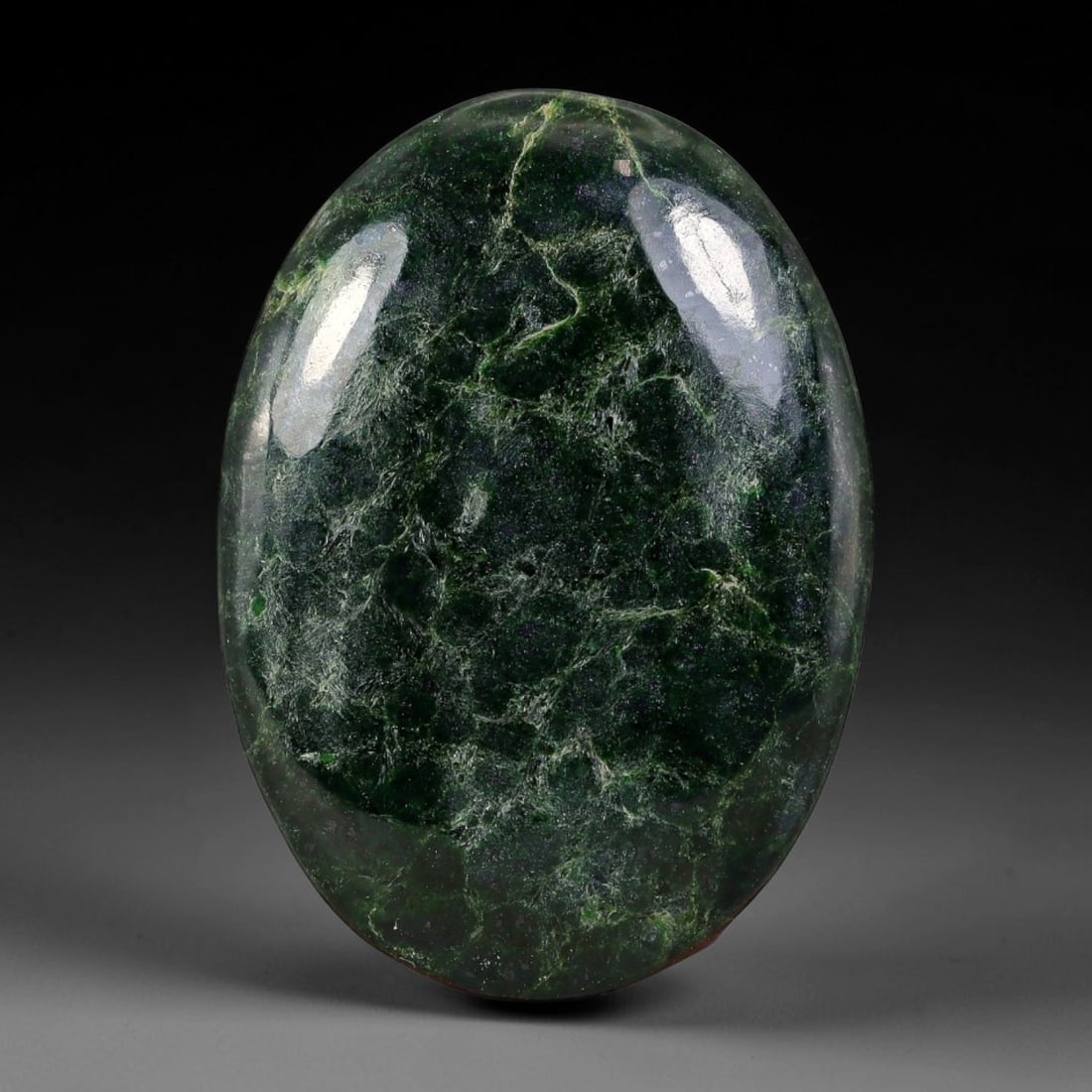 25.46ct Natural Burmese Type A Dark Forest Green Web Vein Jadeite Jade Cabochon, 29FA: This single fully untreated natural Burmese Type A oval jadeite jade cabochon weighs 25.46ct with dimensions of 29x20.8x4.3mm. The cabochon features a dense deep forest green matrix laced with intrica