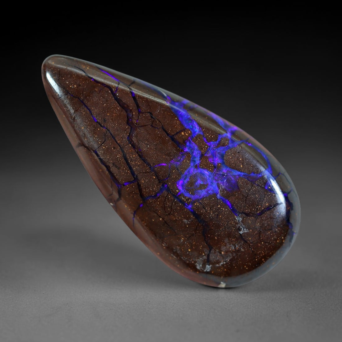 14.62ct Natural Australian Queensland Matrix Boulder Opal Cabochon, 22AV: Hand polished elongated pear teardrop cabochon formed from natural Queensland matrix boulder opal, featuring fine speckled warm brown ironstone host rock crisscrossed with vivid saturated violet-purpl