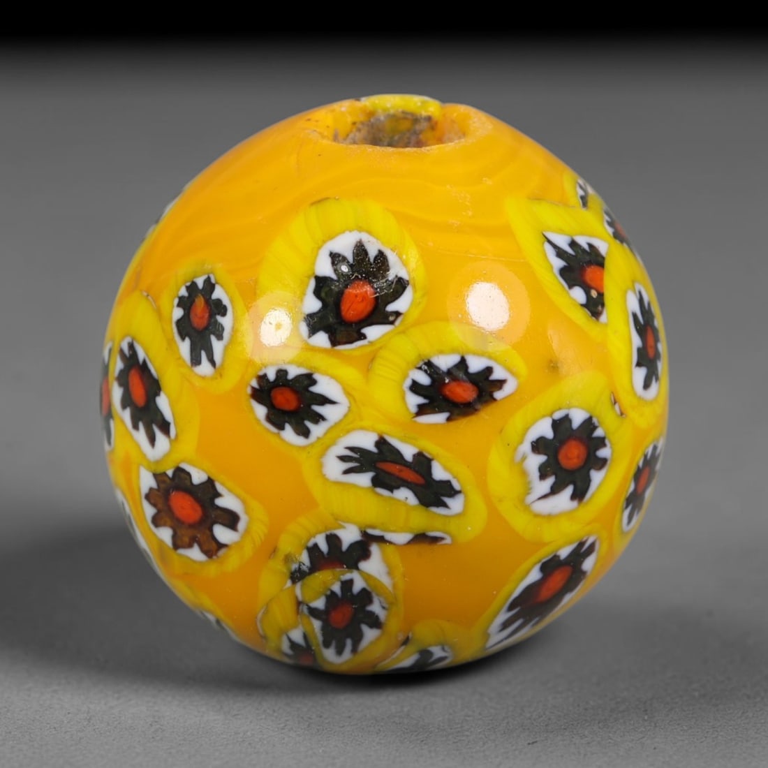 Bright Yellow Millefiori Blown Glass Bead - Handmade Vintage Spherical Ornament, 26AE: Hand-blown saturated golden yellow glass creates this spherical bead, densely covered with embedded millefiori floral cane motifs layered with white, dark brown and vivid red central cores distributed