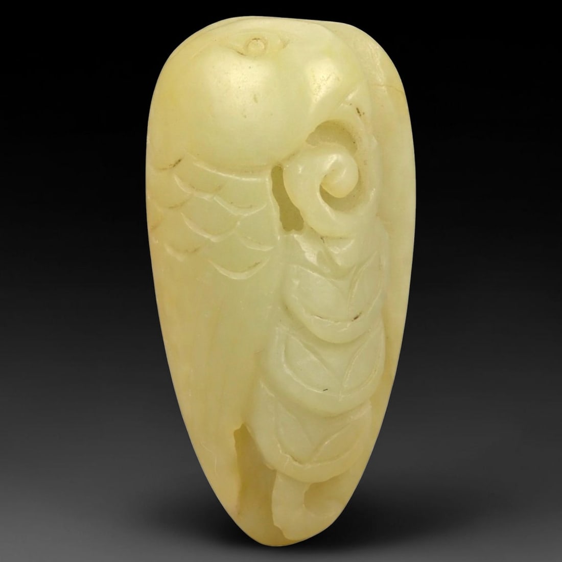 A Chinese Nephrite Jade Fruit Pendant, 58FA: Carved from pale yellow nephrite jade with soft translucency and minor natural inclusions, the pendant is worked in relief to depict a fruiting form, likely a peach or gourd, combined with stylized co