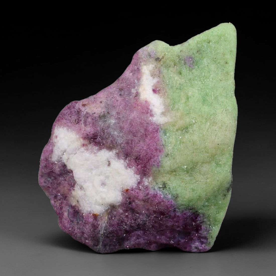 99ct Natural Tanzanian Ruby Zoisite Raw Rough Specimen Mineral Stone, 6FC: This unpolished mineral rough is natural ruby zoisite sourced from Tanzania, exhibiting distinct banded mineral segregation of vibrant green zoisite, magenta ruby crystals, and dark hornblende inclusi