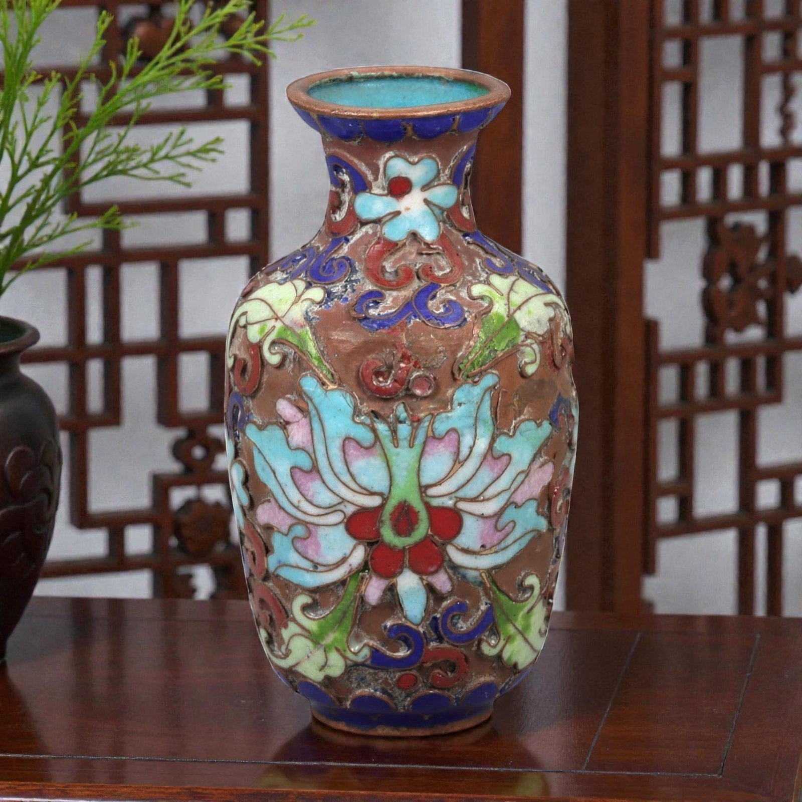 A Chinese Cloisonne Enamel Vase, 20th Century, 2FJ: The vessel is formed from a copper body with applied cloisonne wirework filled with opaque enamel. It is potted with a small ovoid body rising from a narrow foot to a short waisted neck with a flared 