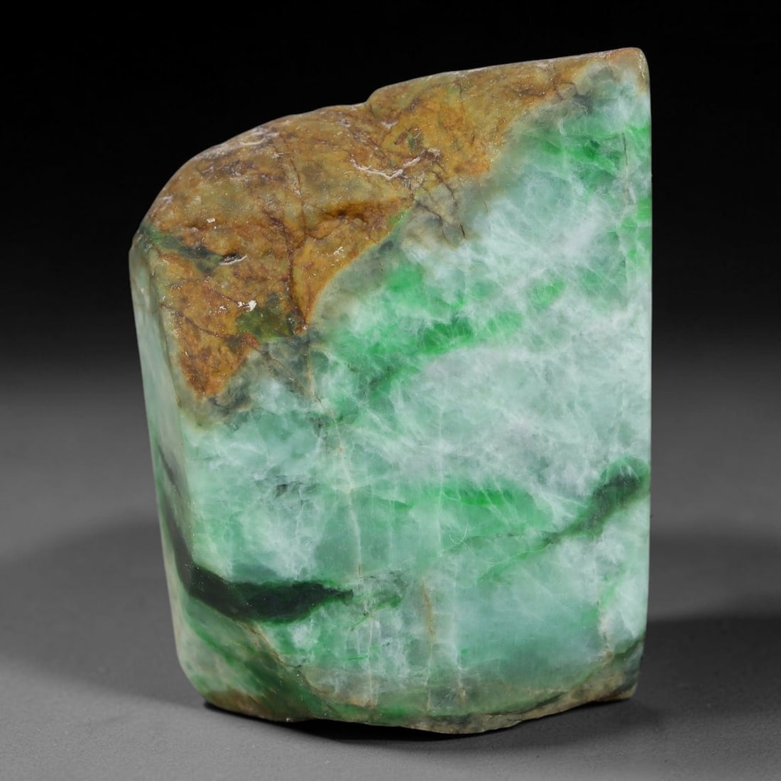 153ct Natural Type A Burmese Jadeite Jade Sliced Rough, 18FB: This specimen is a sliced rough block of natural Type A Burmese jadeite jade. The interior displays natural colour zoning with visible mineral veining and crystalline patterns typical of unprocessed j
