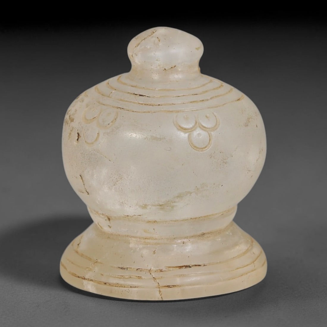 Ancient Medieval Mamluk Islamic Natural Rock Crystal Bell Form Talisman (1250-1517 CE), 97AE: Finely carved translucent rock crystal miniature bell-shaped amulet, featuring concentric incised ring motifs around the domed knob, mid-body and flared pedestal base. Triad circular rosette carvings 