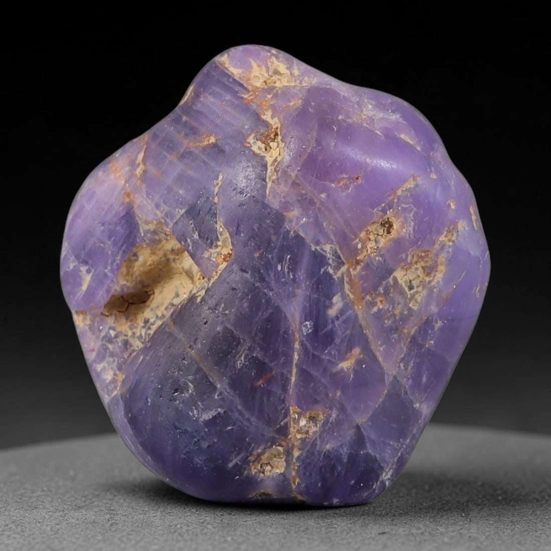 25.89ct Natural Unheated Sri Lankan Purplish Blue Sapphire Rough, 74FC: This natural corundum rough is an unheated purplish blue sapphire sourced from Sri Lankan alluvial gem deposits, featuring an irregular natural native form with residual pale yellow-brown mineral matr
