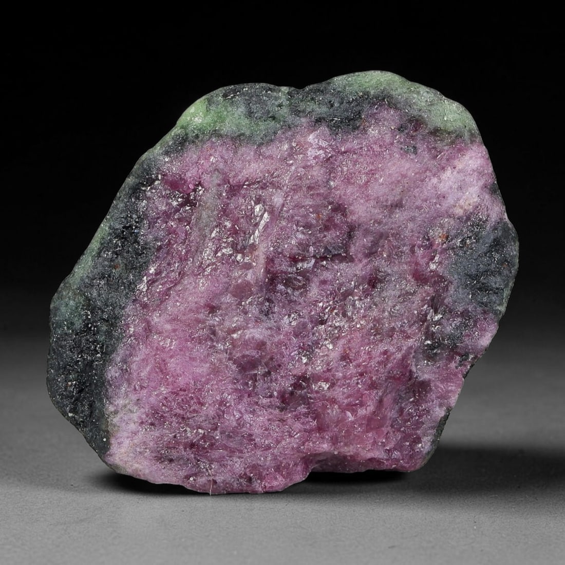 74ct Natural Tanzanian Ruby Zoisite Raw Rough Specimen Mineral Stone, 20FC: This unpolished mineral rough is natural ruby zoisite sourced from Tanzania, exhibiting distinct banded mineral segregation of vibrant green zoisite, magenta ruby crystals, and dark hornblende inclusi