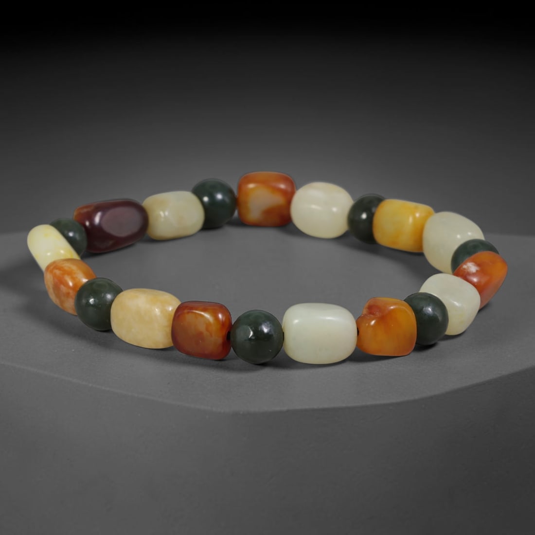Mixed Natural Chinese Xinjiang Hetian Nephrite Jade Multi-Tone Pebble Bracelet, 75AE: Artisan hand-strung bracelet combining polished freeform Xinjiang Hetian nephrite river pebbles and smooth dark green spherical nephrite spacer beads. The pebbles showcase a rich spectrum of natural j