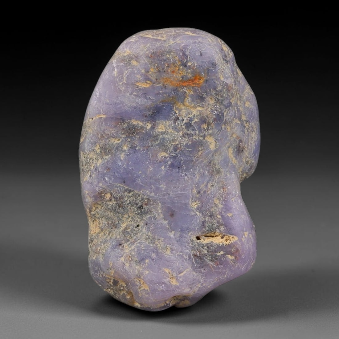 29.62ct Natural Unheated Sri Lankan Purplish Blue Sapphire Rough, 33FC: This natural corundum rough is an unheated purplish blue sapphire sourced from Sri Lankan alluvial gem deposits, featuring an irregular natural native form with residual pale yellow-brown mineral matr