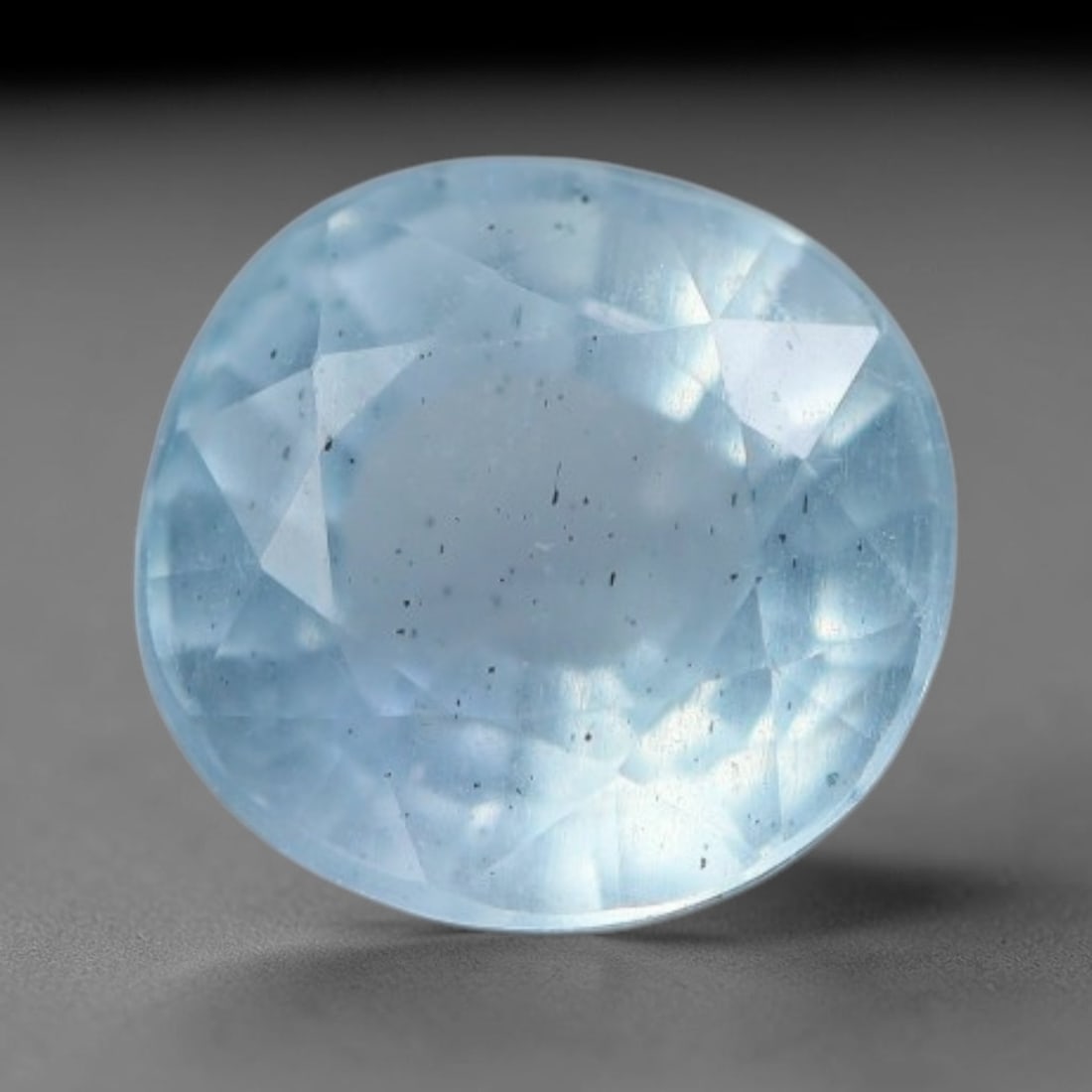 1.12 Carats Natural Brazilian Soft Sky Blue Aquamarine Loose Gemstone, 43AG: This serene sky blue aquamarine carries smooth icy pale blue saturation with gentle light refracting across its polished facets, measured at 6.5x6.5x4.3mm, its cool tranquil tone lends effortless eleg