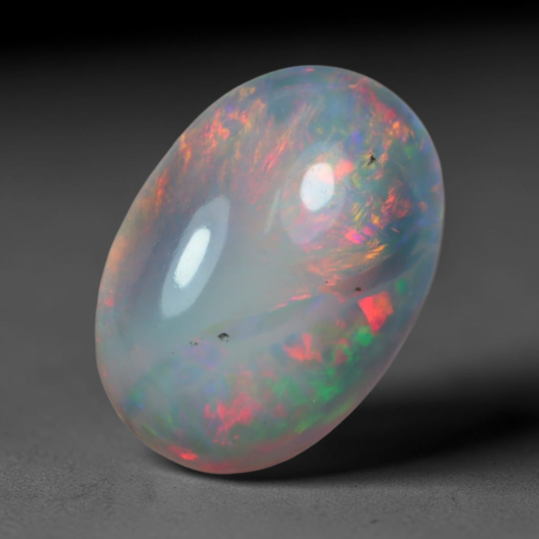 2.43 Carats Natural Ethiopian Welo Black Smoked Opal Cabochon Loose Gemstone, 47AG: This delicate black smoked opal from Ethiopian Welo showcases soft swirling bursts of blush pink, fiery red, mint green and faint lavender play of color floating across a milky translucent base, measu