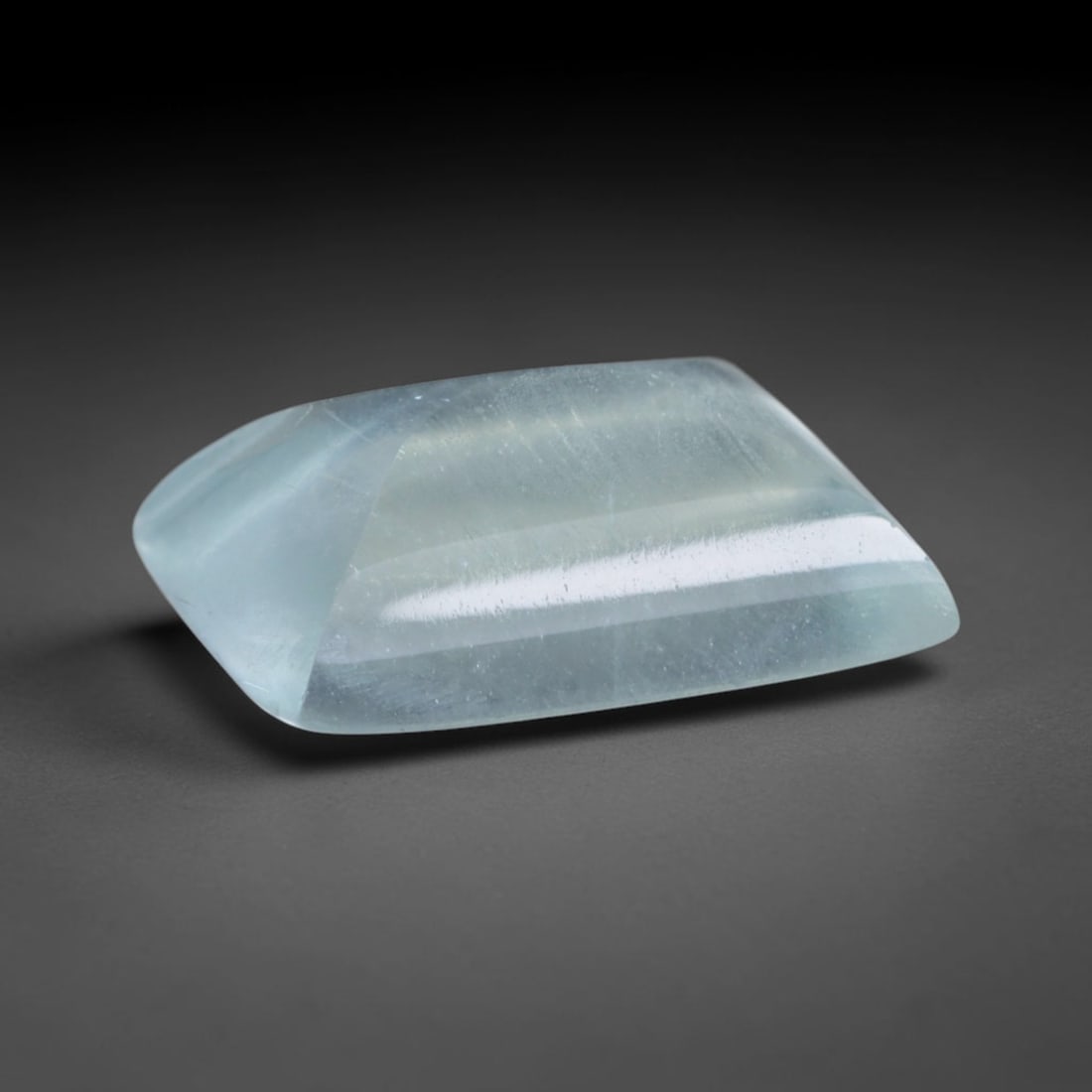 2.65 Carats Natural Brazilian Sky Blue Sugarloaf Aquamarine Loose Gemstone, 68AG: This smooth sugarloaf aquamarine features soft milky sky blue coloring with fine natural fibrous internal inclusions that lend gentle diffused luster across its polished surface, measured at 10.5x7.9x