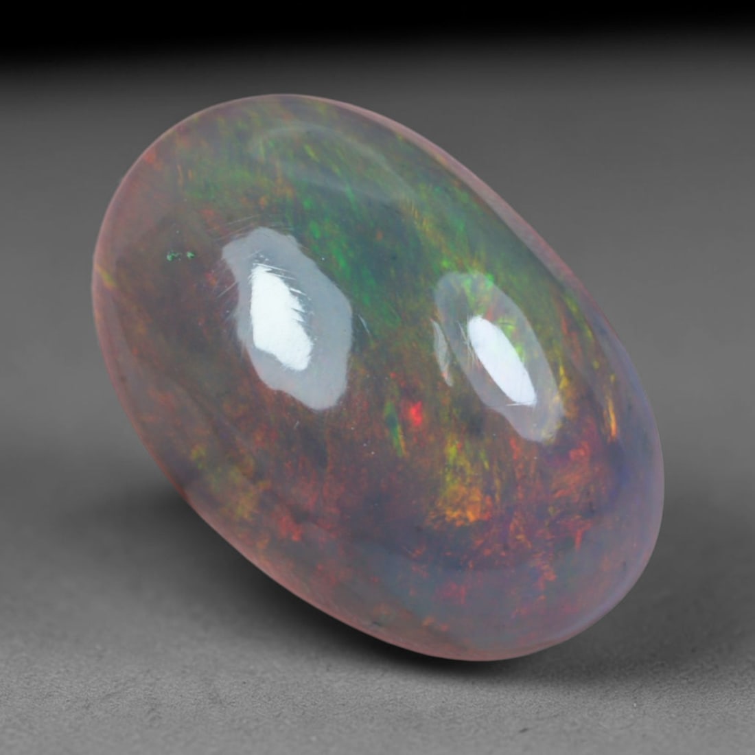 3.14 Carats Natural Ethiopian Welo Black Smoked Opal Cabochon Loose Gemstone, 62AG: This delicate black smoked opal from Ethiopian Welo showcases soft swirling bursts of blush pink, fiery red, mint green and faint lavender play of color floating across a milky translucent base, measu
