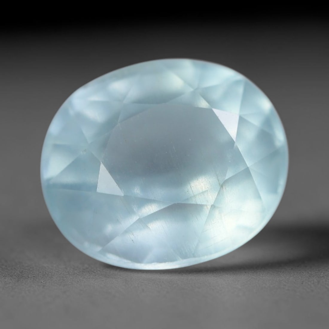 3.25 Carats Natural Brazilian Soft Sky Blue Aquamarine Loose Gemstone, 33AG: This serene sky blue aquamarine carries smooth icy pale blue saturation with gentle light refracting across its polished facets, measured at 10.1x8.7x6.2mm, its cool tranquil tone lends effortless ele