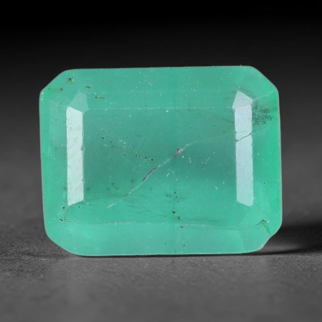 1.03 Carats Natural Zambian Green Emerald Loose Gemstone, 37AH: This green Zambian emerald holds smooth even saturation with subtle faint natural internal markings lending authentic organic character, measured at 6.7x5.2x3.7mm, its calm cool green tone delivers un