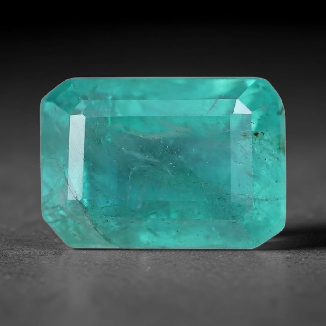 1.53 Carats Natural Zambian Green Emerald Loose Gemstone, 36AH: This green Zambian emerald holds smooth even saturation with subtle faint natural internal markings lending authentic organic character, measured at 7.6x5.3x4.5mm, its calm cool green tone delivers un