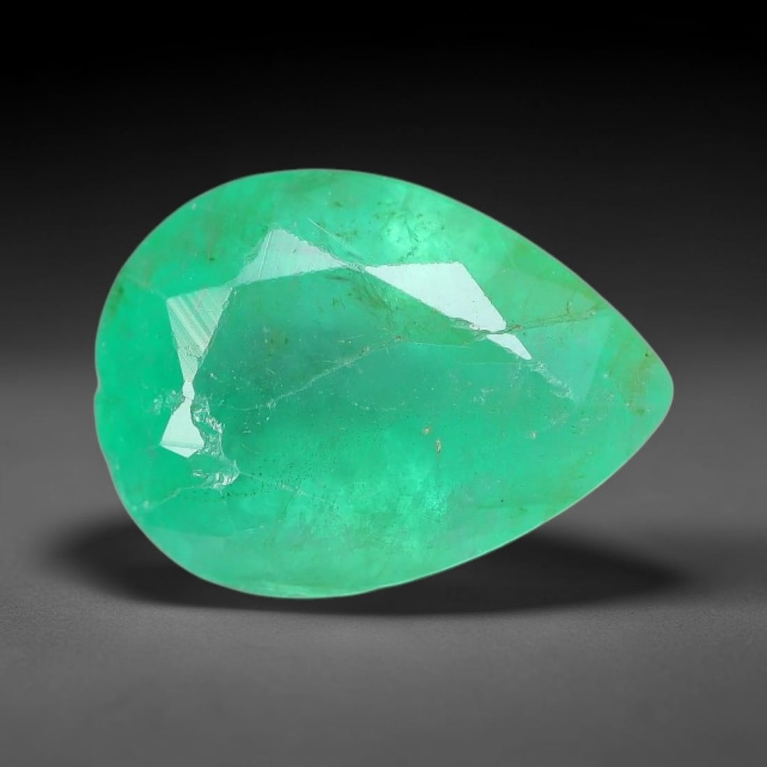 1.52 Carats Natural Zambian Green Emerald Loose Gemstone, 44AH: This green Zambian emerald holds smooth even saturation with subtle faint natural internal markings lending authentic organic character, measured at 9x6.6x4.3mm, its calm cool green tone delivers unde