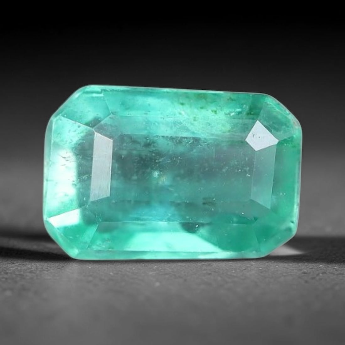 0.56 Carats Natural Zambian Green Emerald Loose Gemstone, 38AH: This green Zambian emerald holds smooth even saturation with subtle faint natural internal markings lending authentic organic character, measured at 6x4x3.1mm, its calm cool green tone delivers unders