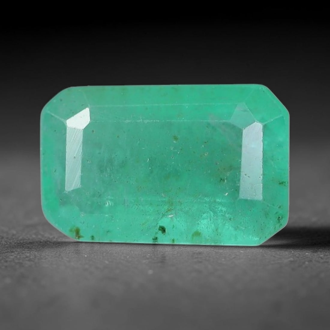1.10 Carats Natural Zambian Green Emerald Loose Gemstone, 29AH: This green Zambian emerald holds smooth even saturation with subtle faint natural internal markings lending authentic organic character, measured at 7.7x5x3.5mm, its calm cool green tone delivers unde