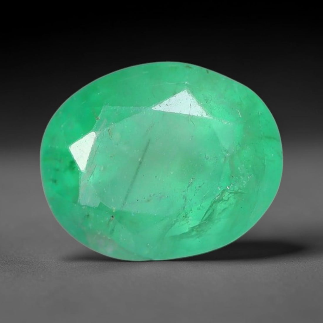 1.40 Carats Natural Zambian Green Emerald Loose Gemstone, 53AH: This green Zambian emerald holds smooth even saturation with subtle faint natural internal markings lending authentic organic character, measured at 7.4x6x5mm, its calm cool green tone delivers unders