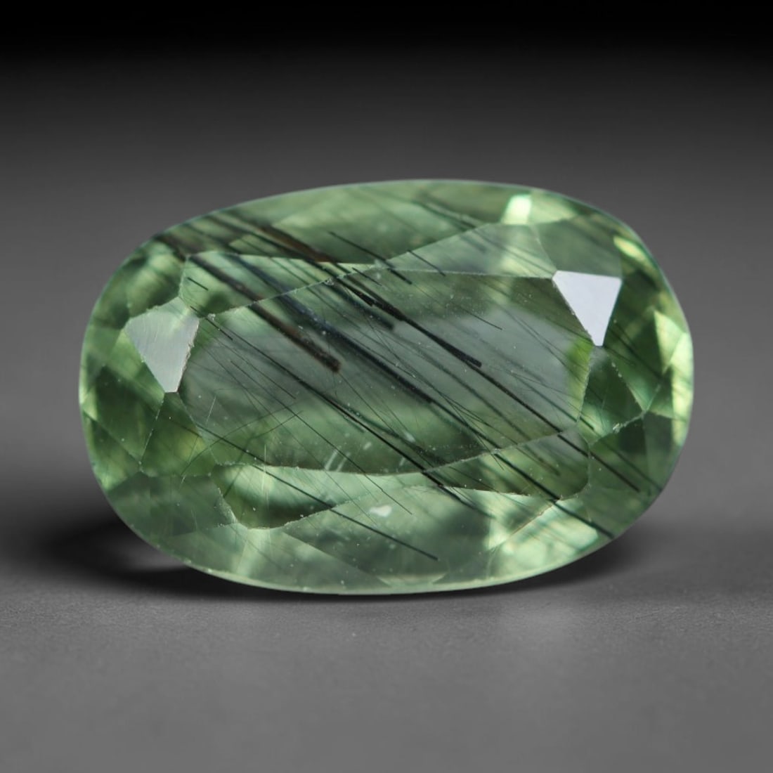 3.06 Carats Natural Pakistani Olive Green Rutilated Peridot Loose Gemstone, 89AH: This translucent peridot displays soft olive green base tone intersected by prominent thin dark needle-like rutile inclusions that create striking linear internal patterns, measured at 10.5x7.2x5mm. P