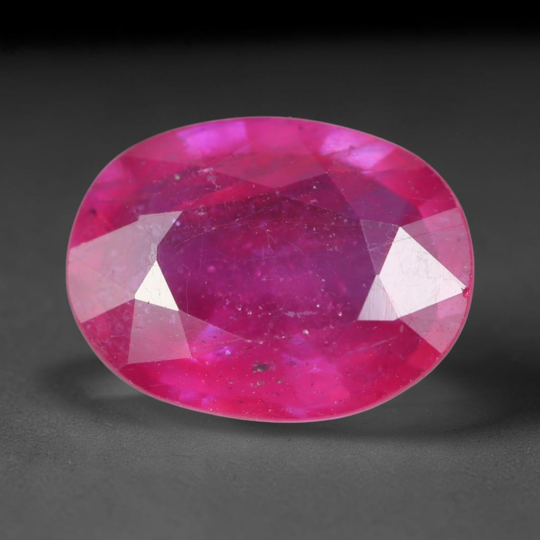 5.68 Carats Natural Madagascar Vivid Magenta Red Ruby Loose Gemstone, 61AH: This vivid magenta-hued Madagascar ruby boasts rich saturated red-pink saturation scattered with tiny fine mineral specks and distinct two-phase fluid bubble inclusions throughout its translucent crys