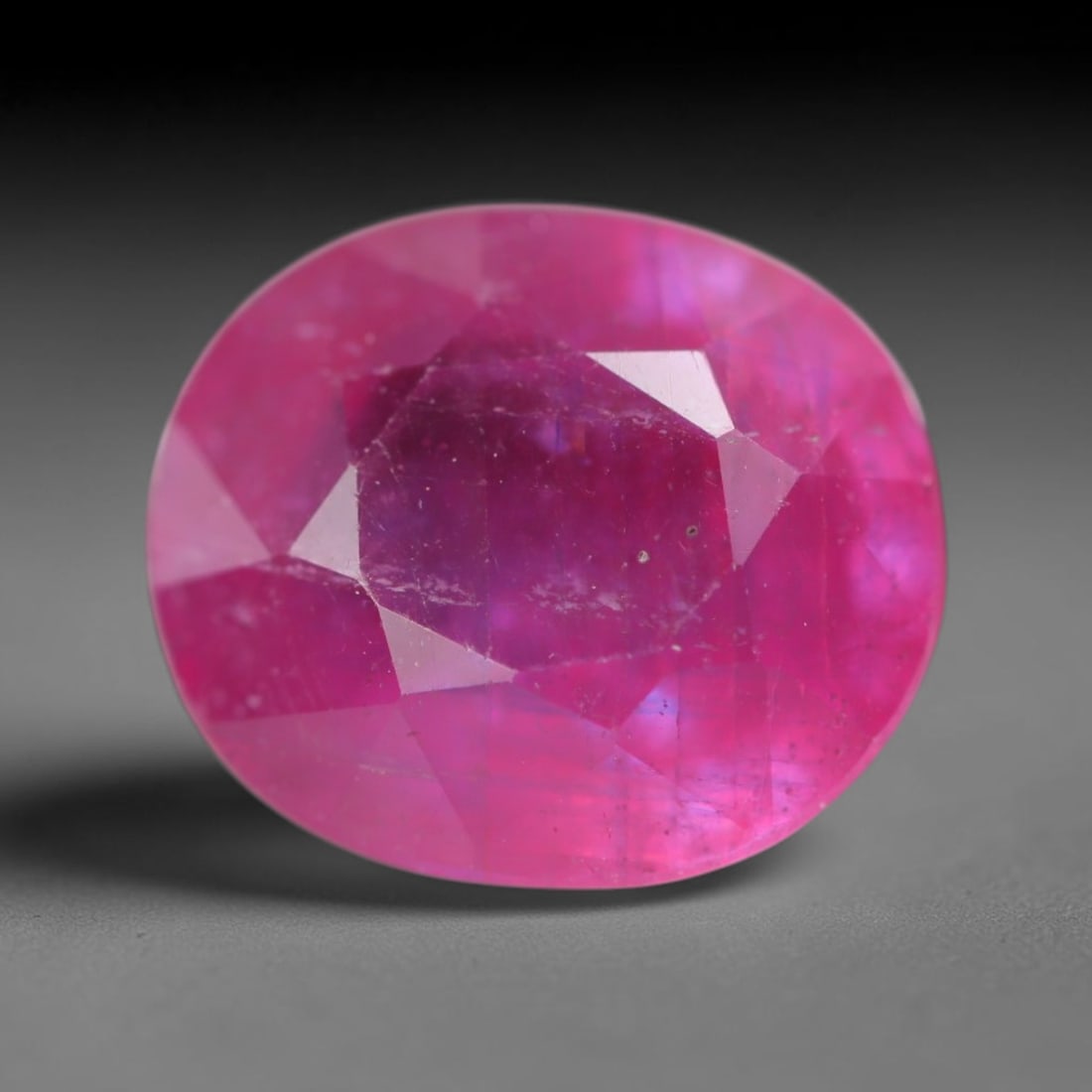5.02 Carats Natural Madagascar Vivid Magenta Red Ruby Loose Gemstone, 63AH: This vivid magenta-hued Madagascar ruby boasts rich saturated red-pink saturation scattered with tiny fine mineral specks and distinct two-phase fluid bubble inclusions throughout its translucent crys