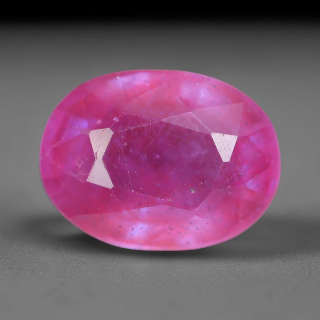 5.51 Carats Natural Madagascar Vivid Magenta Red Ruby Loose Gemstone, 74AH: This vivid magenta-hued Madagascar ruby boasts rich saturated red-pink saturation scattered with tiny fine mineral specks and distinct two-phase fluid bubble inclusions throughout its translucent crys