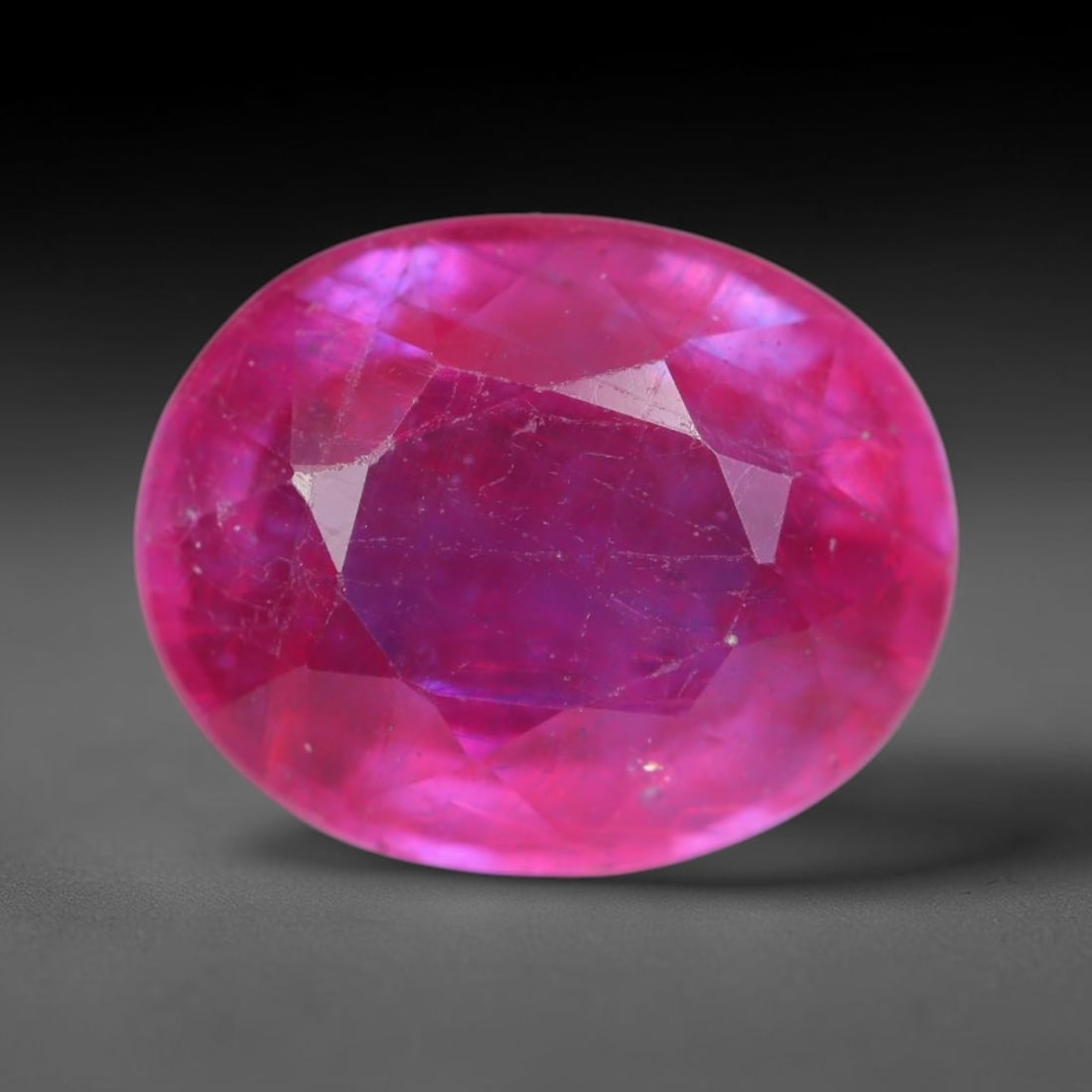 4.83 Carats Natural Madagascar Vivid Magenta Red Ruby Loose Gemstone, 60AH: This vivid magenta-hued Madagascar ruby boasts rich saturated red-pink saturation scattered with tiny fine mineral specks and distinct two-phase fluid bubble inclusions throughout its translucent crys