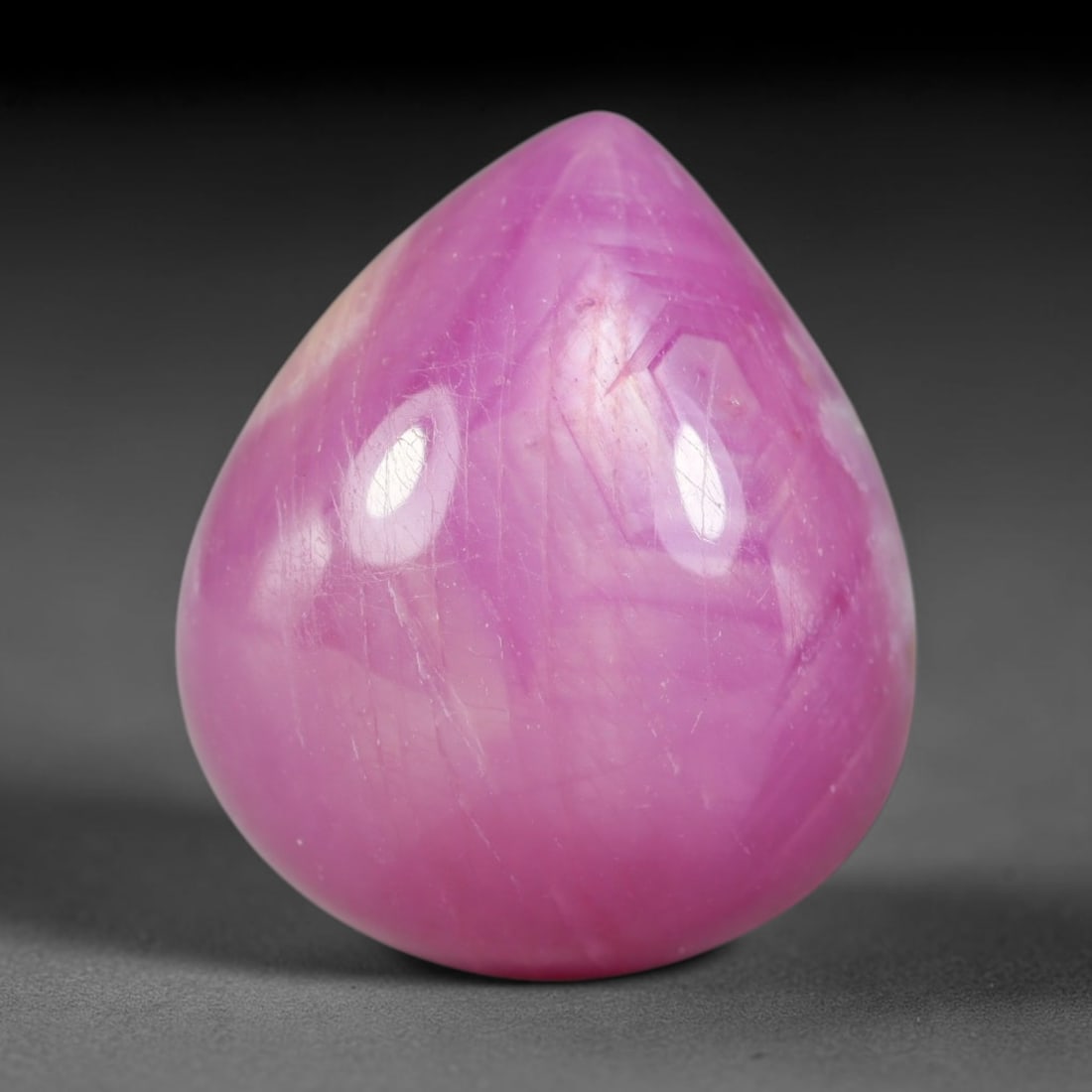 28.50 Carats Natural Madagascar Soft Rose Pink Heated Ruby Cabochon Loose Gemstone, 4AK: This warm blush-toned ruby cabochon carries blended swathes of soft rose pink and gentle peach undertones, with faint natural mineral veining throughout the polished dome, measured at 18.8x16x9.8mm. T