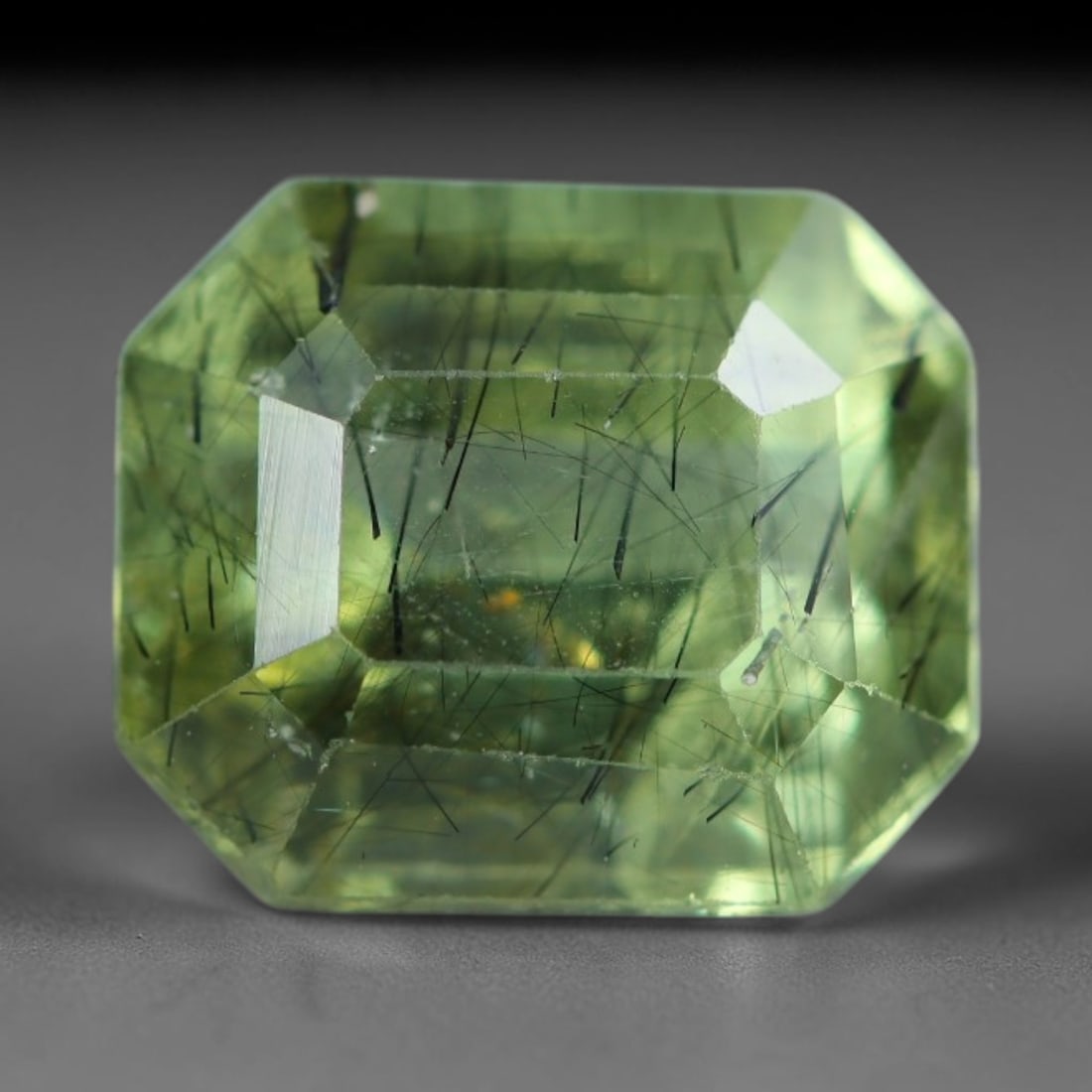 3.08 Carats Natural Pakistani Olive Green Rutilated Peridot Loose Gemstone, 90AH: This translucent peridot displays soft olive green base tone intersected by prominent thin dark needle-like rutile inclusions that create striking linear internal patterns, measured at 8.8x7.5x5.8mm. 