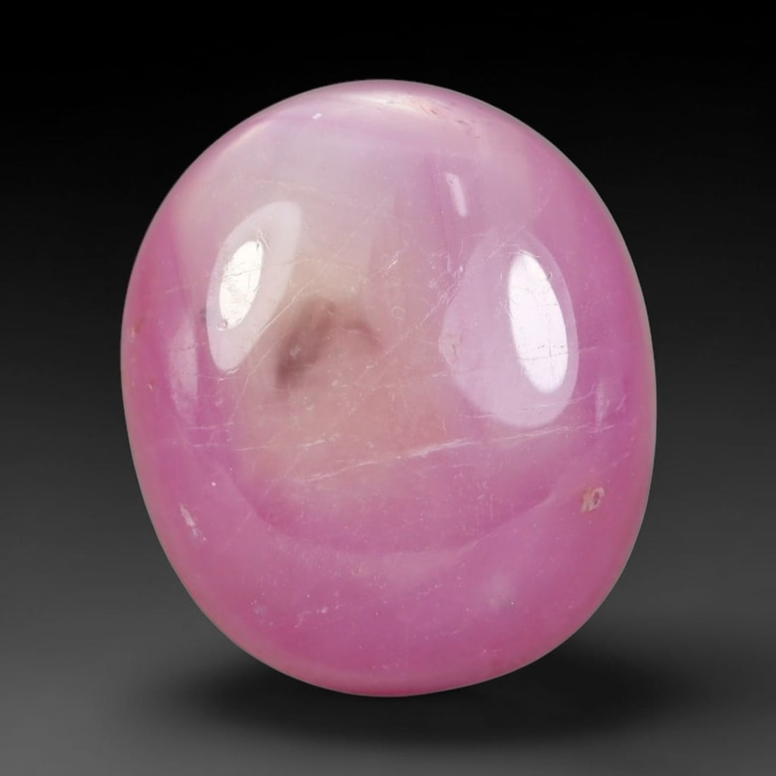9.86 Carats Natural Madagascar Soft Rose Pink Heated Ruby Cabochon Loose Gemstone, 94AH: This warm blush-toned ruby cabochon carries blended swathes of soft rose pink and gentle peach undertones, with faint natural mineral veining throughout the polished dome, measured at 13.2x11.3x5.6mm.