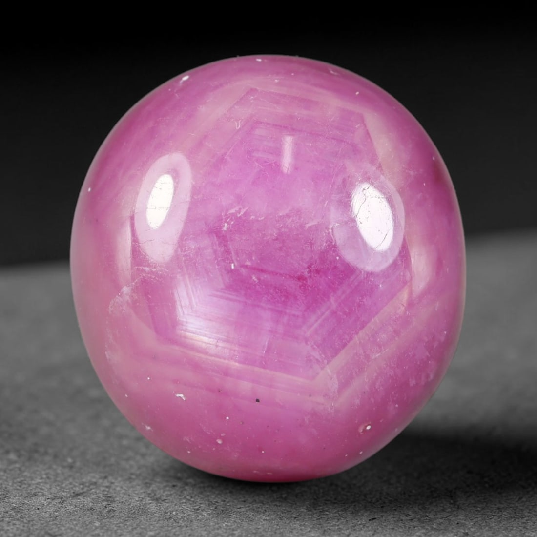 39.24 Carats Natural Madagascar Soft Rose Pink Heated Ruby Cabochon Loose Gemstone, 1AK: This warm blush-toned ruby cabochon carries blended swathes of soft rose pink and gentle peach undertones, with faint natural mineral veining throughout the polished dome, measured at 19.1x17.8x9.8mm.