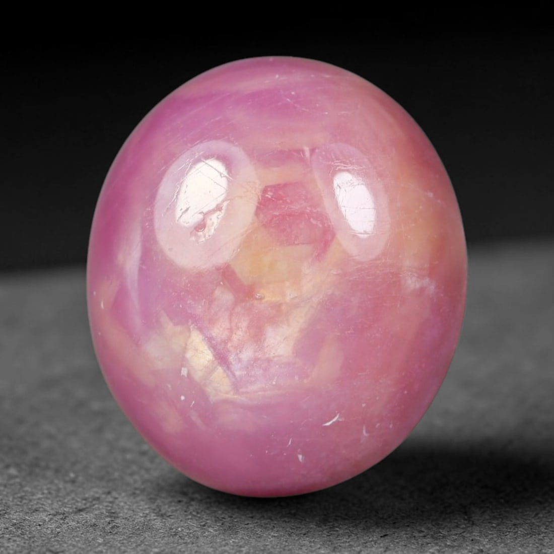12.11 Carats Natural Madagascar Soft Rose Pink Heated Ruby Cabochon Loose Gemstone, 97AH: This warm blush-toned ruby cabochon carries blended swathes of soft rose pink and gentle peach undertones, with faint natural mineral veining throughout the polished dome, measured at 13.6x12x6.5mm. T