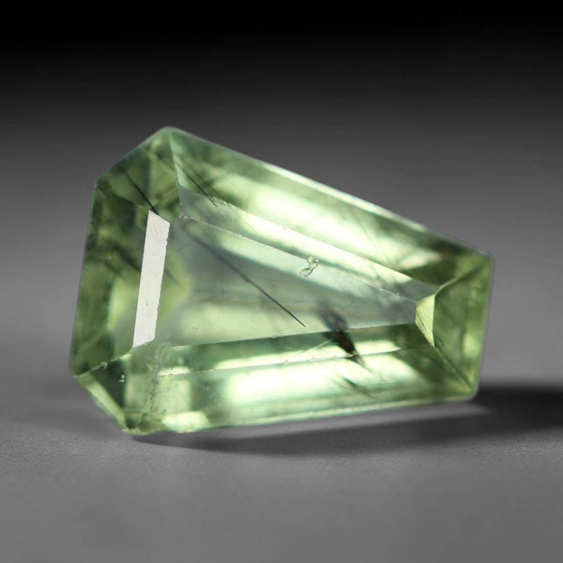 2.20 Carats Natural Pakistani Olive Green Rutilated Peridot Loose Gemstone, 84AH: This translucent peridot displays soft olive green base tone intersected by prominent thin dark needle-like rutile inclusions that create striking linear internal patterns, measured at 9.8x7.4x4.5mm. 