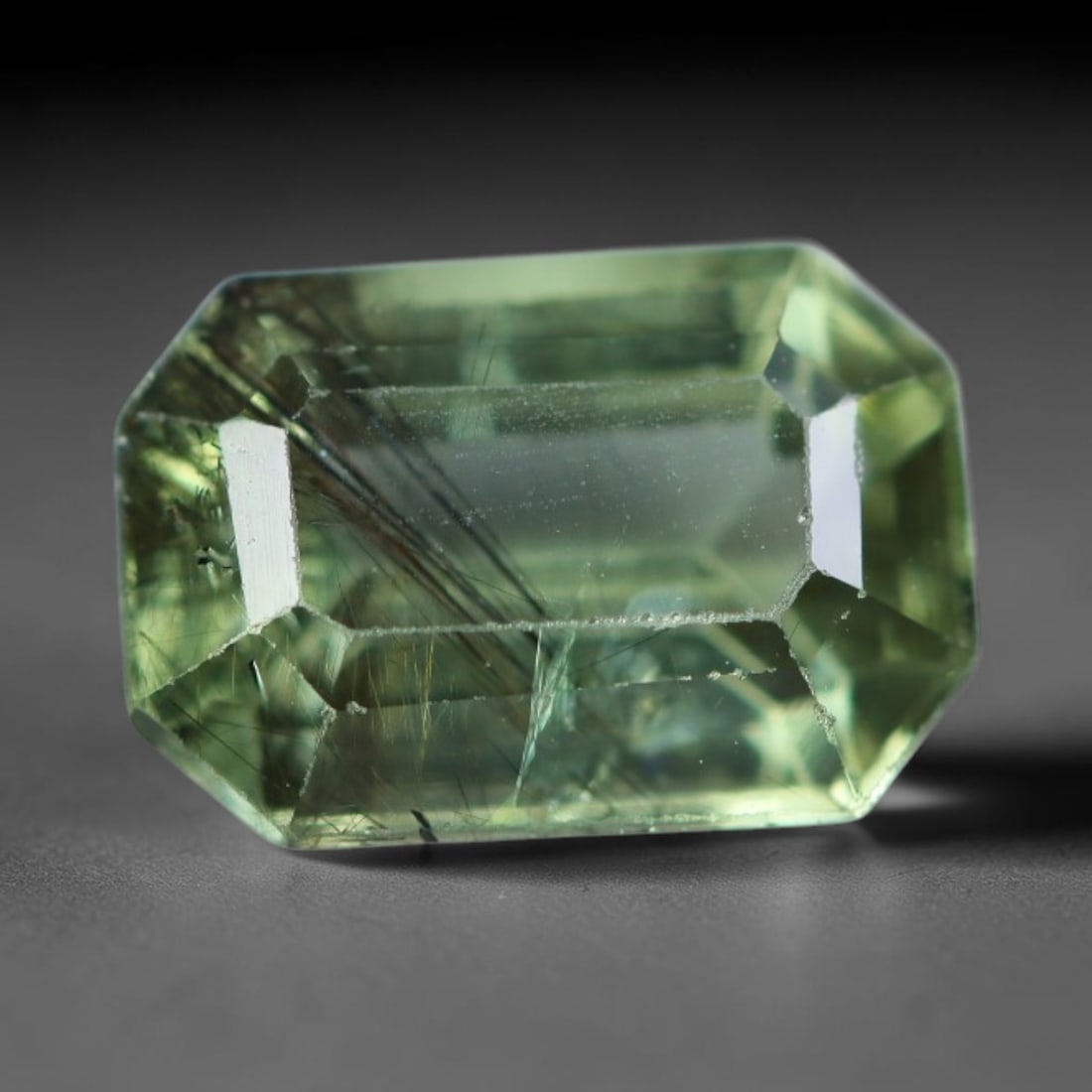 1.95 Carats Natural Pakistani Olive Green Rutilated Peridot Loose Gemstone, 92AH: This translucent peridot displays soft olive green base tone intersected by prominent thin dark needle-like rutile inclusions that create striking linear internal patterns, measured at 8.8x6x4.2mm. Pa