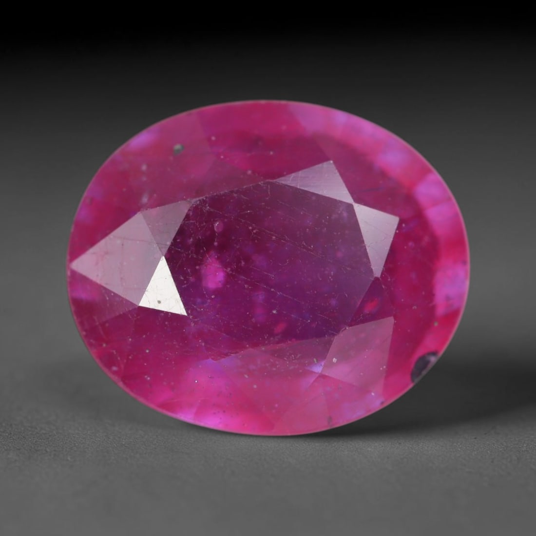 6.20 Carats Natural Madagascar Vivid Magenta Red Ruby Loose Gemstone, 76AH: This vivid magenta-hued Madagascar ruby boasts rich saturated red-pink saturation scattered with tiny fine mineral specks and distinct two-phase fluid bubble inclusions throughout its translucent crys