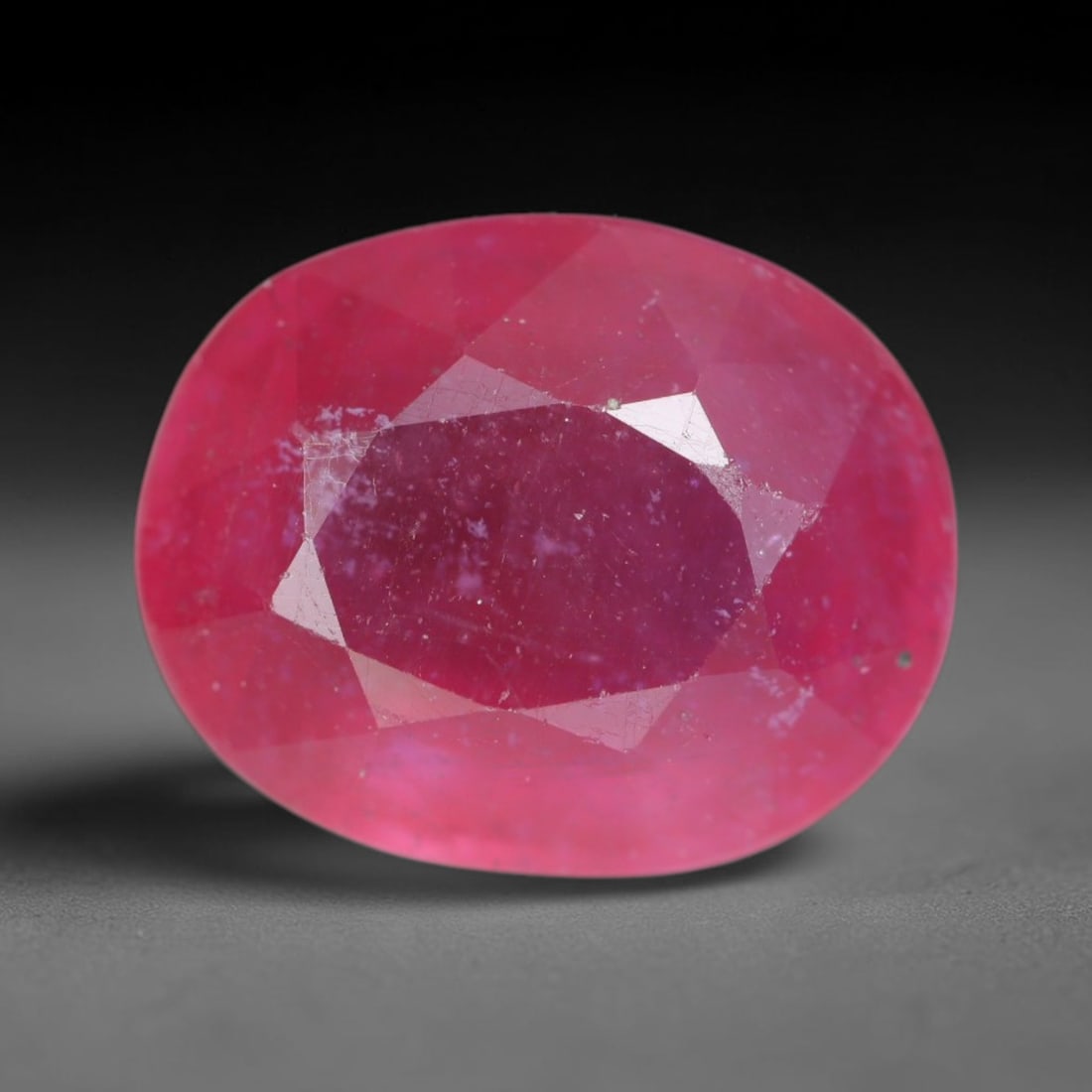 5.20 Carats Natural Madagascar Vivid Magenta Red Ruby Loose Gemstone, 70AH: This vivid magenta-hued Madagascar ruby boasts rich saturated red-pink saturation scattered with tiny fine mineral specks and distinct two-phase fluid bubble inclusions throughout its translucent crys