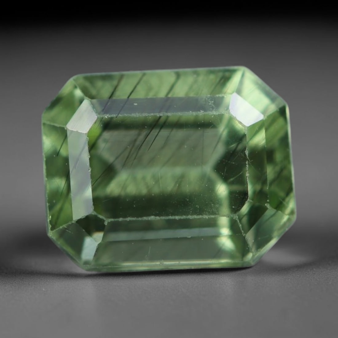2.25 Carats Natural Pakistani Olive Green Rutilated Peridot Loose Gemstone, 88AH: This translucent peridot displays soft olive green base tone intersected by prominent thin dark needle-like rutile inclusions that create striking linear internal patterns, measured at 8x6.4x5mm. Paki