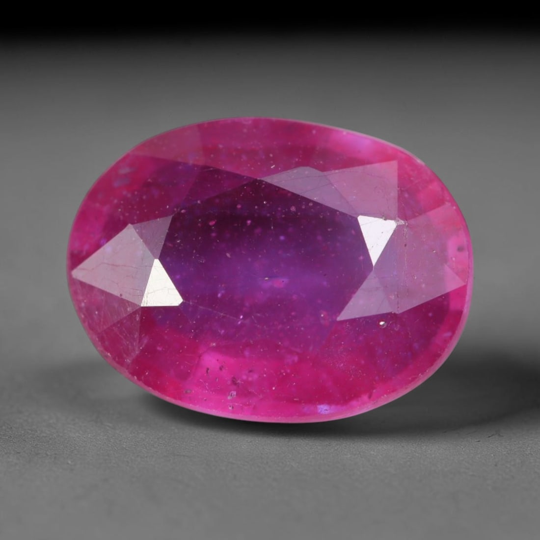 4.34 Carats Natural Madagascar Vivid Magenta Red Ruby Loose Gemstone, 62AH: This vivid magenta-hued Madagascar ruby boasts rich saturated red-pink saturation scattered with tiny fine mineral specks and distinct two-phase fluid bubble inclusions throughout its translucent crys