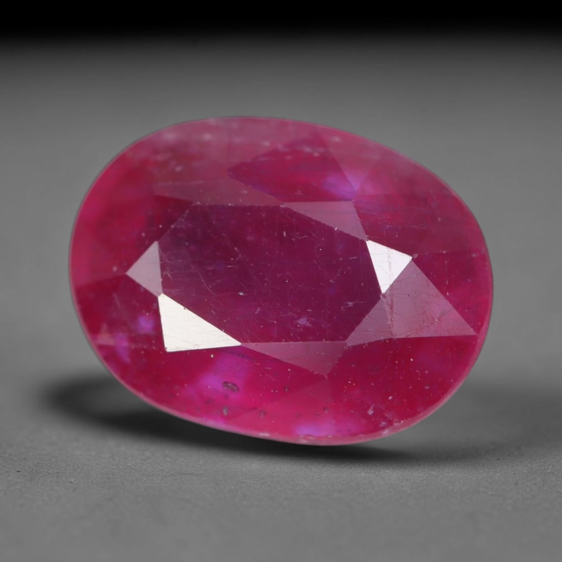 5.78 Carats Natural Madagascar Vivid Magenta Red Ruby Loose Gemstone, 68AH: This vivid magenta-hued Madagascar ruby boasts rich saturated red-pink saturation scattered with tiny fine mineral specks and distinct two-phase fluid bubble inclusions throughout its translucent crys