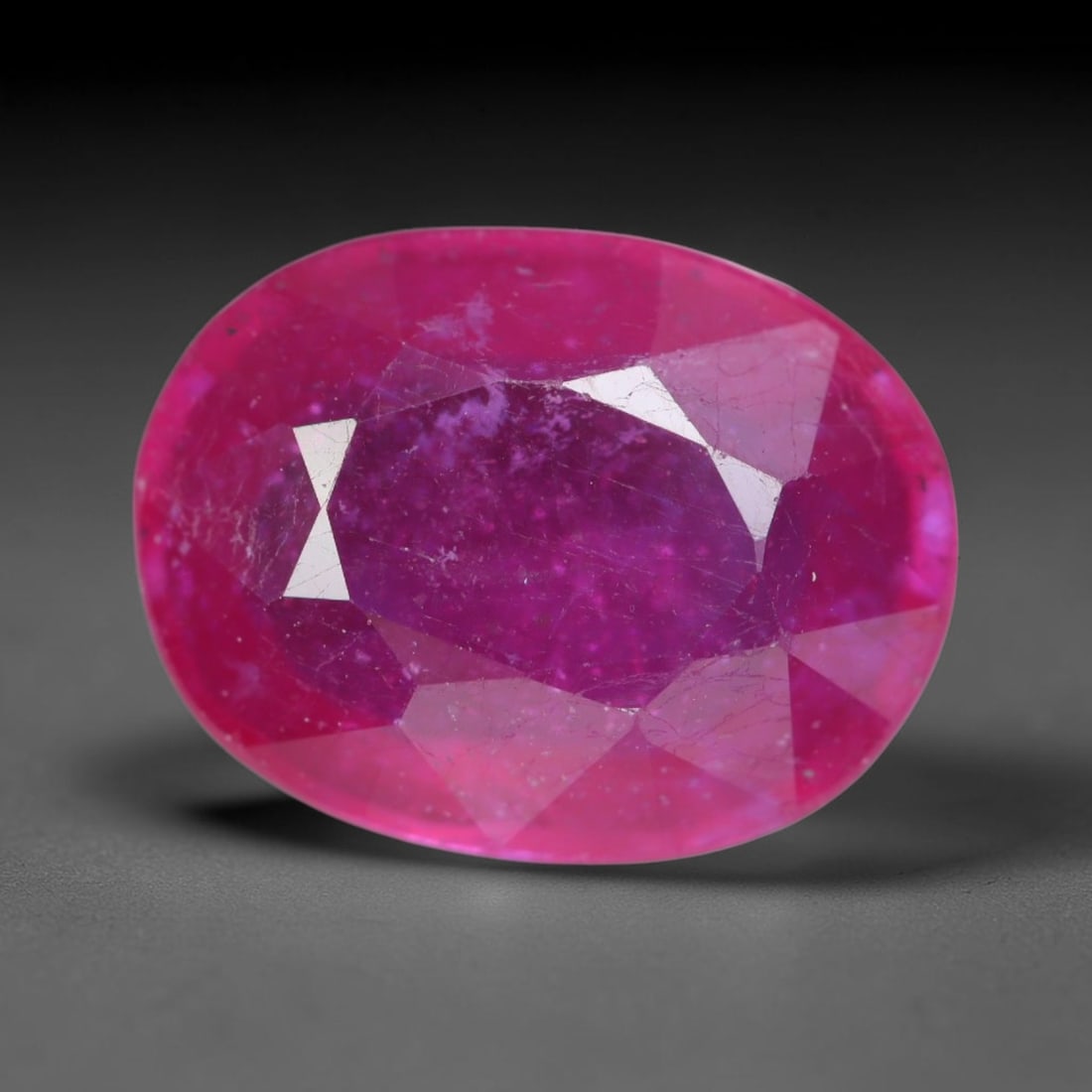 5.52 Carats Natural Madagascar Vivid Magenta Red Ruby Loose Gemstone, 65AH: This vivid magenta-hued Madagascar ruby boasts rich saturated red-pink saturation scattered with tiny fine mineral specks and distinct two-phase fluid bubble inclusions throughout its translucent crys