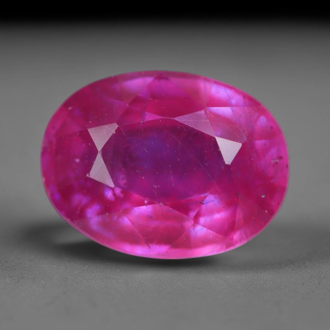 4.57 Carats Natural Madagascar Vivid Magenta Red Ruby Loose Gemstone, 64AH: This vivid magenta-hued Madagascar ruby boasts rich saturated red-pink saturation scattered with tiny fine mineral specks and distinct two-phase fluid bubble inclusions throughout its translucent crys