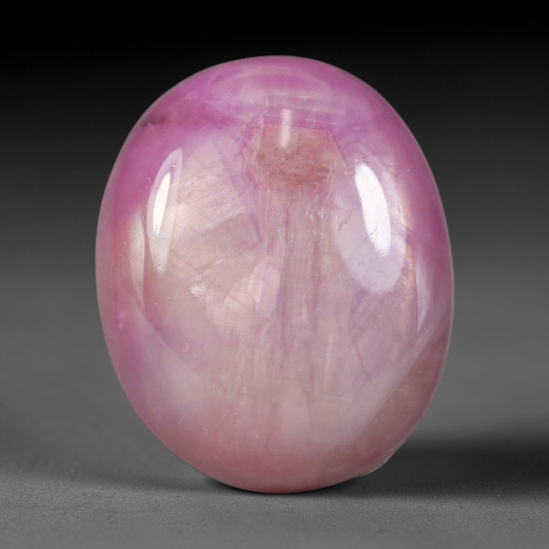 24.10 Carats Natural Madagascar Soft Rose Pink Heated Ruby Cabochon Loose Gemstone, 3AK: This warm blush-toned ruby cabochon carries blended swathes of soft rose pink and gentle peach undertones, with faint natural mineral veining throughout the polished dome, measured at 18.7x15.4x7mm. T