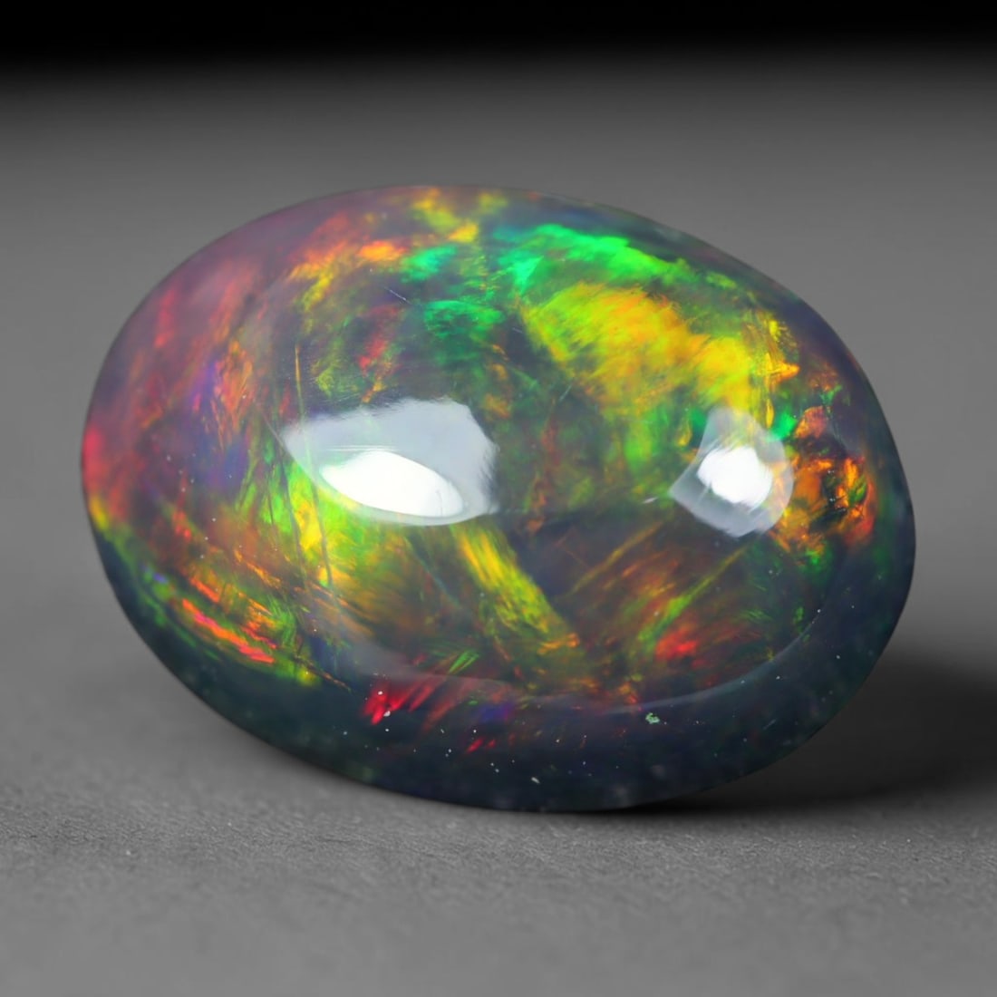 1.84ct Natural Ethiopian Welo Black Smoked Opal Cabochon Loose Gemstone, 68AK: This fully polished Ethiopian Welo opal features a dark smoked base with vivid, sweeping play-of-color shifting across its glossy dome surface, measured at 10.3x7.7x4.4mm. The black smoke treatment de